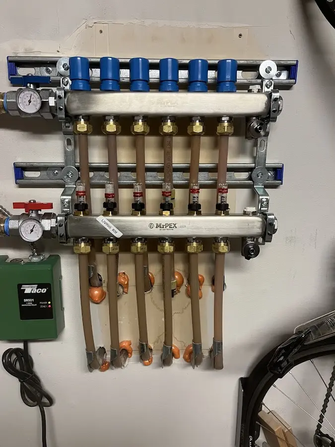 Plumber performing Water Heater Repair at a residential property in Newfield